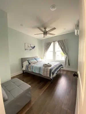 a bedroom with a bed and a ceiling fan at MetLife Stadium Apartments Near NYC in Jersey City