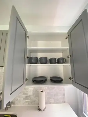 a kitchen with a stove with black plates on it at MetLife Stadium Apartments Near NYC in Jersey City