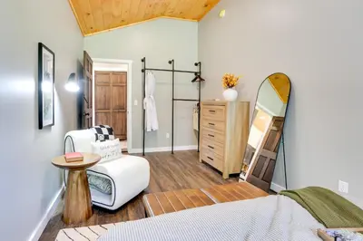 a bedroom with a bed and a dresser and a mirror at Delaware River Access Peaceful Farm Retreat! in Callicoon