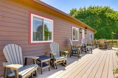 a deck with chairs and tables on a house at Delaware River Access Peaceful Farm Retreat! in Callicoon