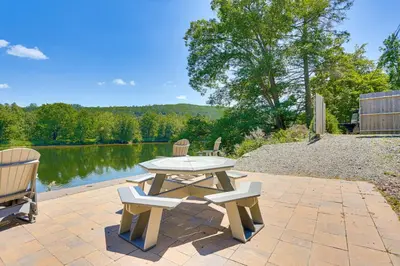 a picnic table and two chairs next to a lake at Delaware River Access Peaceful Farm Retreat! in Callicoon