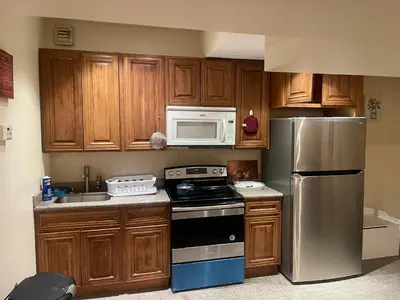 a kitchen with a stove and a microwave at Peculiar 96 in Newark