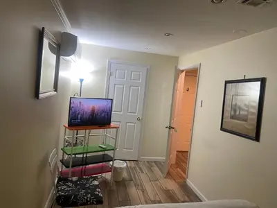a living room with a tv on a shelf at Peculiar 96 in Newark