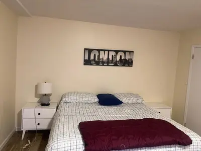 a bedroom with a bed and a sign on the wall at Peculiar 96 in Newark