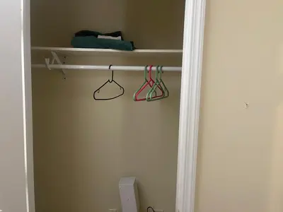 a closet with shelves and hangers in a room at Peculiar 96 in Newark