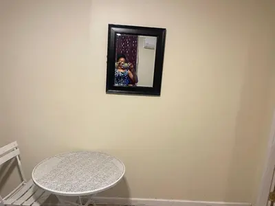 a person taking a picture in a mirror on a wall at Peculiar 96 in Newark