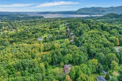 an aerial view of a park with trees and a lake at Enchanting Historic Home near West Point Beacon in Cornwall-on-Hudson