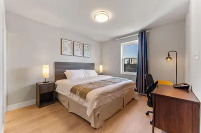 a hotel room with a bed and a desk and a desk at 4211 Suites in Philadelphia