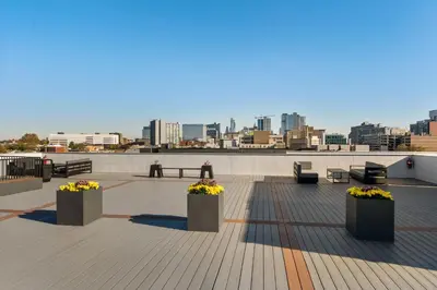 a rooftop with benches and flowers on a building at 4211 Suites in Philadelphia
