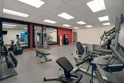 a gym with lots of cardio equipment in a room at Homewood Suites by Hilton Hamilton, NJ in Hamilton