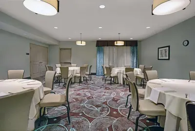 a conference room with tables and chairs and a podium at Homewood Suites by Hilton Hamilton, NJ in Hamilton
