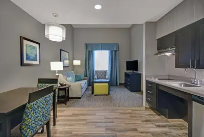 a hotel room with a kitchen and a living room at Homewood Suites by Hilton Hamilton, NJ in Hamilton
