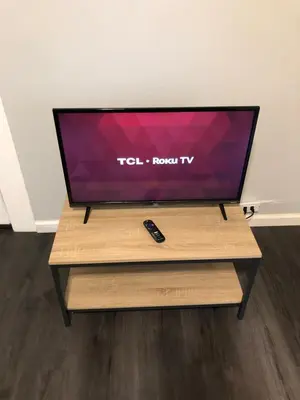 a flat screen tv sitting on top of a wooden table at Private 2-bedroom apartment, free parking, direct bus to NYC Manhattan only 2 blocks away, MetLife Stadium FIFA World Cup 25 minutes away in Linden