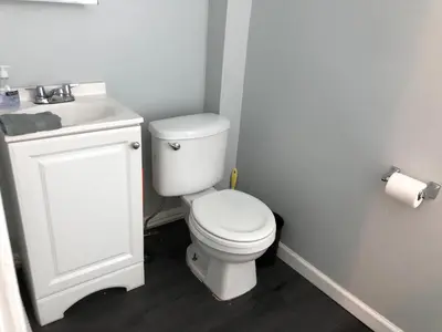 a bathroom with a white toilet and a sink at Private 2-bedroom apartment, free parking, direct bus to NYC Manhattan only 2 blocks away, MetLife Stadium FIFA World Cup 25 minutes away in Linden
