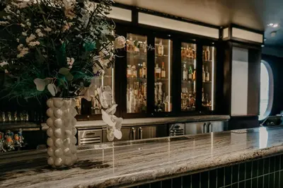a vase with flowers on a counter in a bar at Hotel Indigo Lower East Side New York by IHG in New York