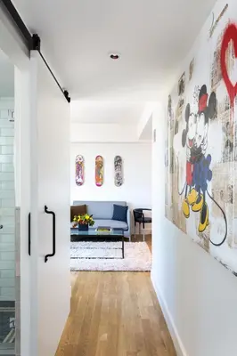 a hallway with a door leading to a living room at Hotel Indigo Lower East Side New York by IHG in New York