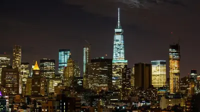 a city skyline at night with the spire of a skyscraper at Hotel Indigo Lower East Side New York by IHG in New York