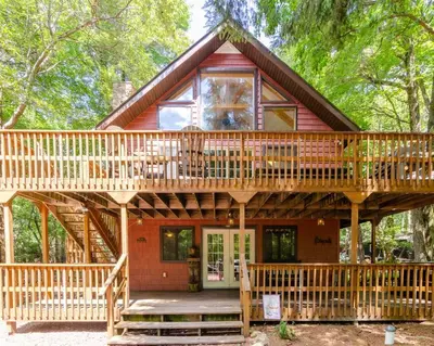 a large wooden house with a large deck at Hot Tub l Walk to Lake Harmony l Minutes to Ski in Lake Harmony