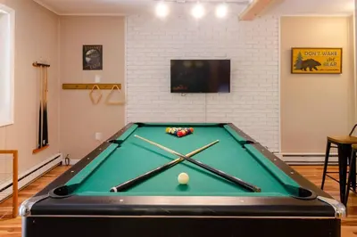 a pool table with cue balls on top of it at Hot Tub l Walk to Lake Harmony l Minutes to Ski in Lake Harmony