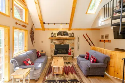 a living room with a couch and a fireplace at Hot Tub l Walk to Lake Harmony l Minutes to Ski in Lake Harmony