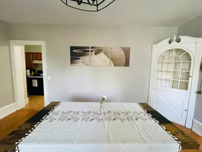a bedroom with a white bed with a vase on it at Stylish & Charming 2BR Monthly Discount in Elkins Park