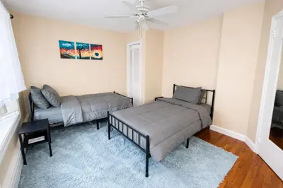 a living room with two beds and a couch at Stylish & Charming 2BR Monthly Discount in Elkins Park
