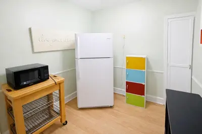 a white refrigerator in a room with a tv at Stylish & Charming 2BR Monthly Discount in Elkins Park