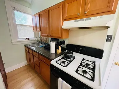 a kitchen with a black and white stove top oven at Stylish & Charming 2BR Monthly Discount in Elkins Park