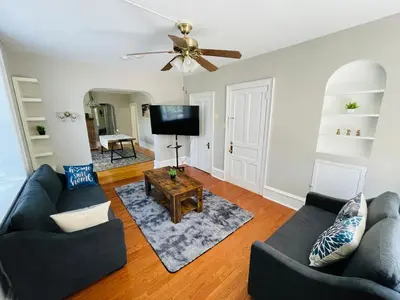 a living room with two couches and a flat screen tv at Stylish & Charming 2BR Monthly Discount in Elkins Park