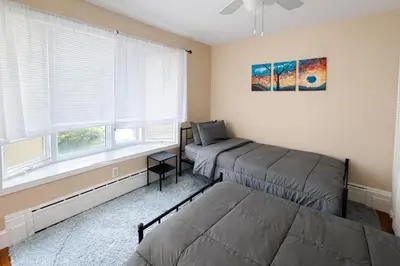 a bedroom with two beds and a window at Stylish & Charming 2BR Monthly Discount in Elkins Park