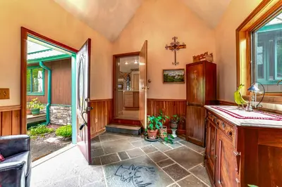 a kitchen with a sink and an open door at Secluded Oxford Cabin on 75 Acres Sunset Views! in Oxford