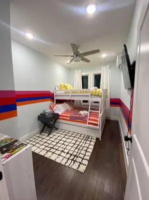 a room with two bunk beds and a ceiling at Heart of NY - 17 min to Empire State & Times Sq in Jersey City