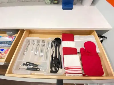 a drawer in a kitchen with utensils and a tray at Heart of NY - 17 min to Empire State & Times Sq in Jersey City