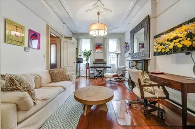a living room with a couch and a table at Artist Residence 3 Bedroom Brownstone in Hoboken