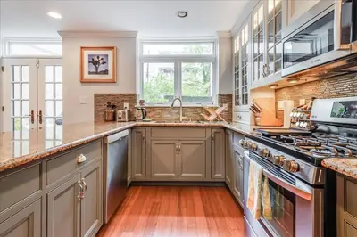 a kitchen with a sink and a stove at Artist Residence 3 Bedroom Brownstone in Hoboken