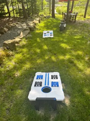 a barbecue grill sitting on the grass in a yard at Majestic Lake Front Chalet in Tobyhanna