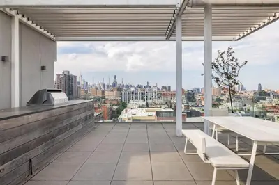 a balcony with a table and a view of the city at Travive New York Brand New Five Bedroom Penthouse in New York