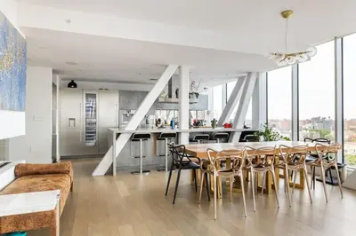 a kitchen with a table and chairs in a room at Travive New York Brand New Five Bedroom Penthouse in New York