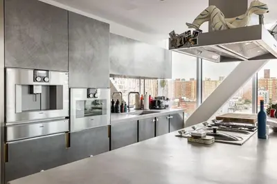 a kitchen with stainless steel appliances and a large window at Travive New York Brand New Five Bedroom Penthouse in New York