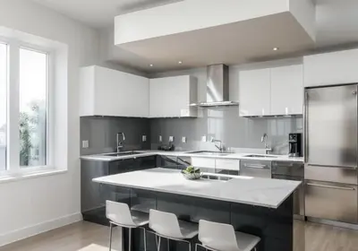 a kitchen with white cabinets and a large island at Travive New York Brand New Five Bedroom Penthouse in New York