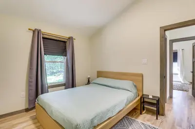 a bedroom with a bed and a window at Private Hot Tub Charming Poconos Cabin! in Albrightsville