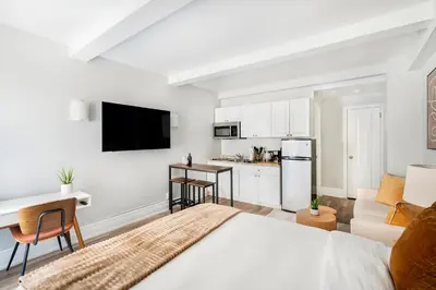 a living room with a bed and a kitchen at 73-410 Luxury 24 DM New Studio UWS Gym Laundry in New York