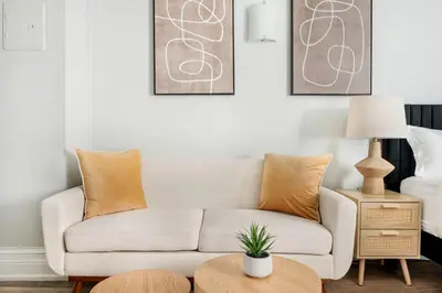 a living room with a couch and a table at 73-410 Luxury 24 DM New Studio UWS Gym Laundry in New York