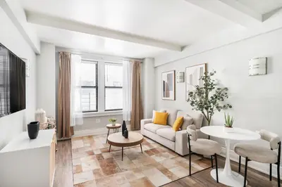 a living room with a couch and a table at 73-406 New 1BR 1Bth UWS Doorman Gym in New York