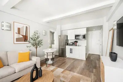 a living room with a couch and a table at 73-406 New 1BR 1Bth UWS Doorman Gym in New York