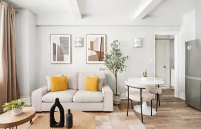 a living room with a couch and a table at 73-406 New 1BR 1Bth UWS Doorman Gym in New York