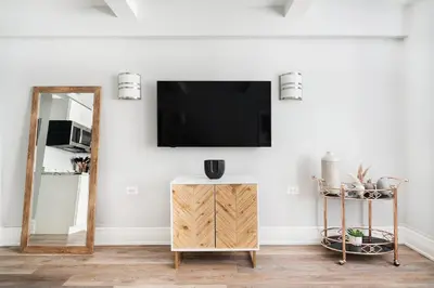 a living room with a flat screen tv on the wall at 73-406 New 1BR 1Bth UWS Doorman Gym in New York