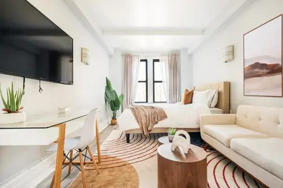 a living room with a bed and a desk at 73-1111 New Studio UWS Doorman Gym in New York