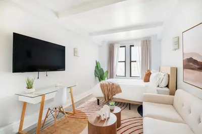 a white living room with a bed and a desk at 73-1111 New Studio UWS Doorman Gym in New York