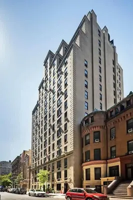 a large tall building with cars parked in front of it at 73-1111 New Studio UWS Doorman Gym in New York